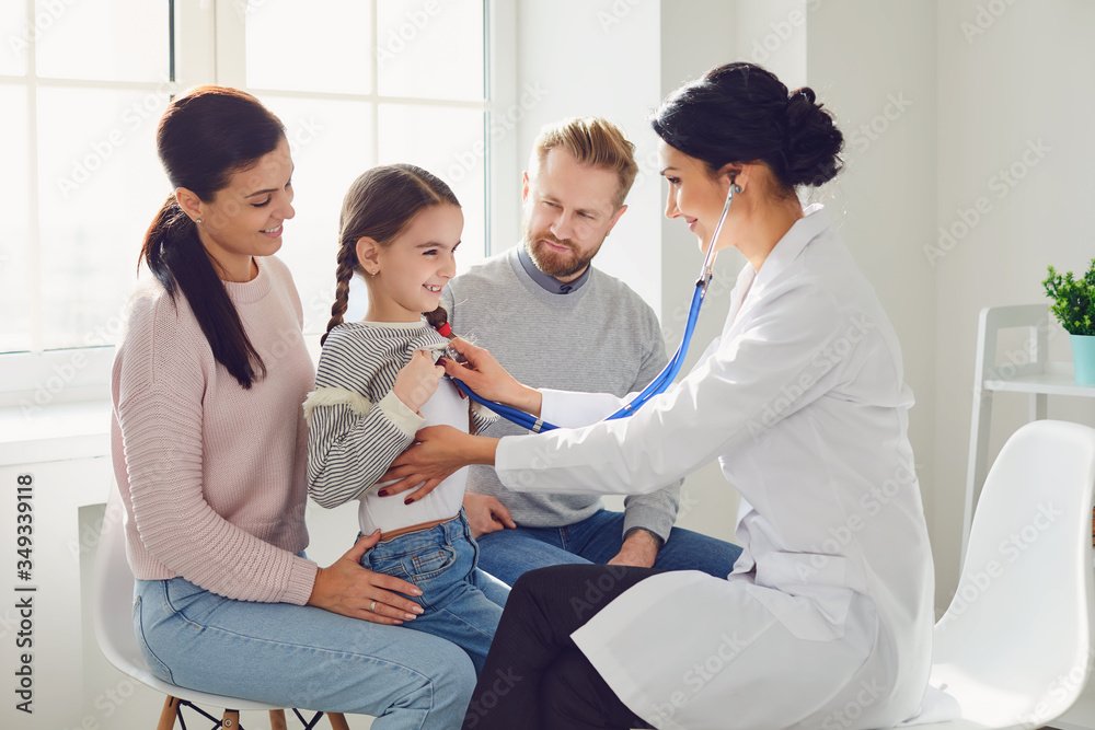 Happy family on a visit to the doctor in the office of a doctor.